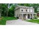 Two-story home with stone accents, a covered porch, and a well-maintained lawn and a concrete driveway at 1735 15Th Street Ne Pl, Hickory, NC 28601