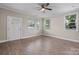 Living room with hardwood floors, ceiling fan, and several windows at 1735 15Th Street Ne Pl, Hickory, NC 28601