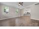 Spacious living room with vinyl floors, two windows, and an open layout leading to the kitchen area at 1735 15Th Street Ne Pl, Hickory, NC 28601