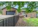 Back exterior view of home featuring an outdoor deck, metal fence and lush greenery at 174 Wintergreen Cir, Statesville, NC 28677