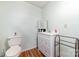 Bathroom with a vanity, toilet, wood-look flooring, and a towel rack at 174 Wintergreen Cir, Statesville, NC 28677