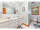 Bright bathroom with double sink vanity, clean white tile and large mirror at 174 Wintergreen Cir, Statesville, NC 28677