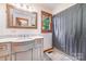 Tastefully designed bathroom with marble floors, vanity, and decorative mirror at 174 Wintergreen Cir, Statesville, NC 28677