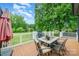Outdoor deck area with a patio set, grill, and outdoor umbrella with a view of the backyard at 174 Wintergreen Cir, Statesville, NC 28677