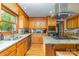 Bright kitchen featuring wood cabinets, granite counters, tiled backsplash, and stainless steel appliances at 174 Wintergreen Cir, Statesville, NC 28677