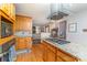 Open concept kitchen boasting a granite island cooktop and natural wood cabinets at 174 Wintergreen Cir, Statesville, NC 28677