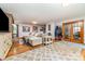Spacious living room with cozy fireplace, plush sectional, and bright light from French doors at 174 Wintergreen Cir, Statesville, NC 28677