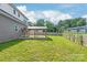 A spacious backyard with a well-maintained lawn, a wooden fence, and a covered patio area at 1832 Montclair Ave, Gastonia, NC 28054