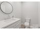 Contemporary bathroom with sleek vanity, round mirror, and modern fixtures at 1832 Montclair Ave, Gastonia, NC 28054