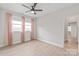 Bedroom featuring neutral walls, ceiling fan, and light-colored flooring at 1832 Montclair Ave, Gastonia, NC 28054