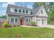 Charming home featuring a red door, two-car garage, and well-maintained landscaping at 1832 Montclair Ave, Gastonia, NC 28054
