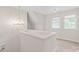 Hallway featuring hardwood floors, modern lighting, and a staircase leading to the next level at 1832 Montclair Ave, Gastonia, NC 28054