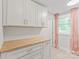 Laundry room features updated cabinetry, countertop, and window at 1832 Montclair Ave, Gastonia, NC 28054