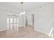 Open-concept living room featuring light hardwood floors, modern lighting, and seamless transition to outdoor living with french doors at 1832 Montclair Ave, Gastonia, NC 28054