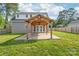 Backyard with an impressive wood pergola and a well-maintained lawn at 1832 Montclair Ave, Gastonia, NC 28054