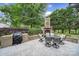 Outdoor patio features a brick fireplace, seating, and grill, perfect for entertaining at 2218 Legacy Oak Dr, Waxhaw, NC 28173
