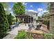 Relaxing back yard with brick fire place and outdoor seating, pergola and covered porch at 2218 Legacy Oak Dr, Waxhaw, NC 28173