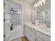 Well-lit bathroom with double sinks, white cabinets, and view into the adjacent bedroom at 2218 Legacy Oak Dr, Waxhaw, NC 28173