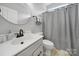 Cozy bathroom features a modern sink, toilet, shower with a curtain, and a neutral color scheme at 2218 Legacy Oak Dr, Waxhaw, NC 28173