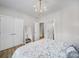 Bright bedroom with hardwood floors, overhead lighting, closet, ensuite bathroom, and neutral colors at 2218 Legacy Oak Dr, Waxhaw, NC 28173