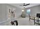 Bright bedroom with a chair, desk, exercise bike, and french doors leading outside at 2218 Legacy Oak Dr, Waxhaw, NC 28173