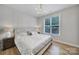 Cozy bedroom boasts hardwood floors, natural light from a window, and a comfortable bed at 2218 Legacy Oak Dr, Waxhaw, NC 28173
