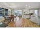 Open-concept dining area showcases a wooden table, seamless flow to the living room and modern kitchen at 2218 Legacy Oak Dr, Waxhaw, NC 28173