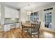 Bright dining area features a wooden table, stylish light fixture, and a built-in desk with white cabinetry at 2218 Legacy Oak Dr, Waxhaw, NC 28173