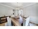 Elegant dining room with modern chandelier, hardwood floors, and neutral decor sets the stage for formal gatherings at 2218 Legacy Oak Dr, Waxhaw, NC 28173