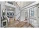 Bright and airy foyer with hardwood floors, staircase, and French doors leading to additional living spaces at 2218 Legacy Oak Dr, Waxhaw, NC 28173