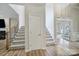 Grand foyer featuring a staircase with patterned carpet and views into the adjoining rooms at 2218 Legacy Oak Dr, Waxhaw, NC 28173