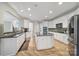 Spacious open-concept kitchen with island, stainless steel appliances, and abundant cabinet space is perfect for entertaining at 2218 Legacy Oak Dr, Waxhaw, NC 28173