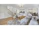 Spacious living room features hardwood floors, neutral décor, stairway access, and seamless flow at 2218 Legacy Oak Dr, Waxhaw, NC 28173