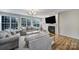Bright living room with a fireplace, mounted TV, large windows, and comfortable seating at 2218 Legacy Oak Dr, Waxhaw, NC 28173
