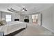 Spacious main bedroom featuring a fireplace, tray ceiling, and adjoining access to another area of the home at 2218 Legacy Oak Dr, Waxhaw, NC 28173
