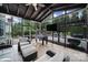 Inviting screened porch with comfortable seating, ceiling fan, mounted TV, and views of the backyard at 2218 Legacy Oak Dr, Waxhaw, NC 28173