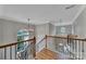 Elegant staircase with hardwood treads, wrought iron spindles, and natural light from large windows at 2218 Legacy Oak Dr, Waxhaw, NC 28173
