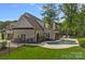 Scenic backyard showcasing a pool, patio, and well-manicured lawn and landscaping at 2309 Ethan Way, Weddington, NC 28104