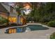 Backyard pool and patio area with outdoor furniture, next to a white brick home under a twilight sky at 2309 Ethan Way, Weddington, NC 28104