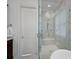 Bathroom with a glass-enclosed shower featuring marble tiles, a built-in bench and shower head at 2309 Ethan Way, Weddington, NC 28104