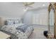 Cozy bedroom with a ceiling fan, a large window, and a comfortable queen-sized bed at 2309 Ethan Way, Weddington, NC 28104