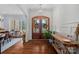 Bright foyer featuring hardwood floors, a decorative chandelier, and a charming wood double-door entryway at 2309 Ethan Way, Weddington, NC 28104