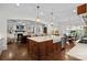 Spacious kitchen with a large island, farmhouse sink, and hardwood floors at 2309 Ethan Way, Weddington, NC 28104
