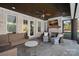 Relaxing covered patio area with a fireplace and comfortable seating at 2309 Ethan Way, Weddington, NC 28104