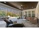Covered patio with ceiling fan, comfortable seating, and views of the pool and backyard at 2309 Ethan Way, Weddington, NC 28104