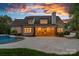 Exterior rear view of a white brick home with a large patio and an in-ground pool under a twilight sky at 2309 Ethan Way, Weddington, NC 28104