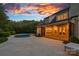White brick home with an in-ground pool, patio and outdoor furniture under a colorful twilight sky at 2309 Ethan Way, Weddington, NC 28104