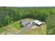 Aerial view showcases this property's full layout, featuring pool, detached shop, green space, and a long drive at 2489 Highway 161 S Hwy, York, SC 29745