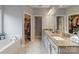 Main bathroom with double sinks, granite counters, walk-in closet, and a soaking tub at 2489 Highway 161 S Hwy, York, SC 29745