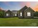 Charming single-story brick home with well-manicured lawn, black shutters and a beautiful sunset at 2489 Highway 161 S Hwy, York, SC 29745